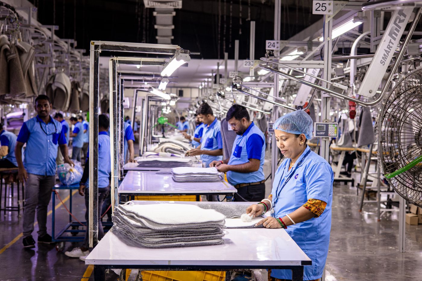 Workers checking garments in a textile production facility